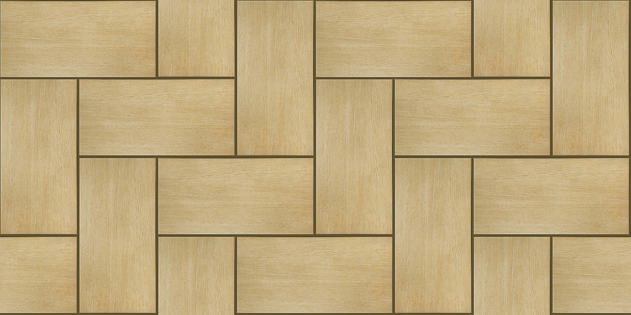 Large-format beige porcelain tile being installed on a bathroom floor